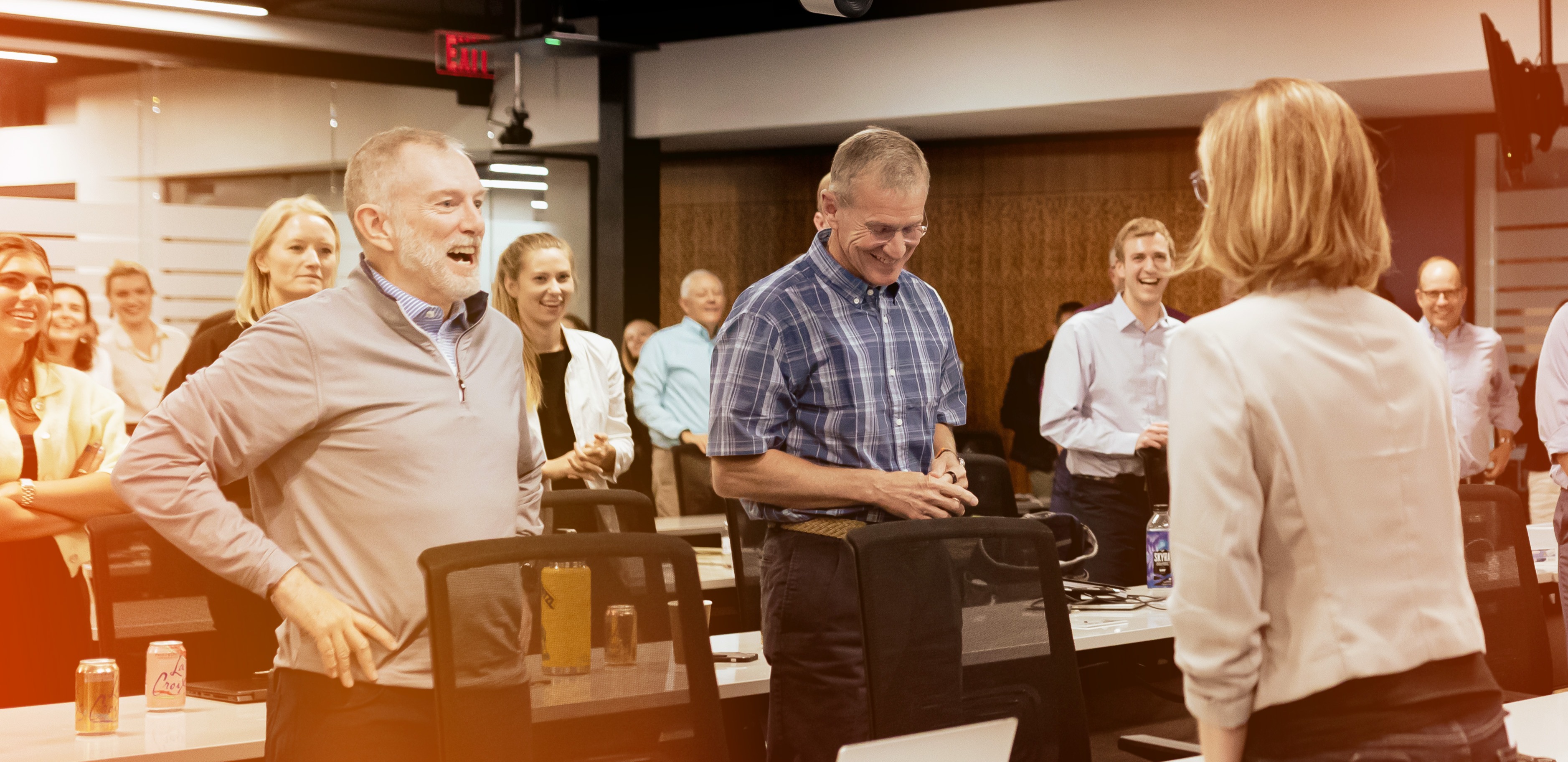 McChrystalGroup-About-OurTeam.jpg Colleagues Standing in a Room Smiling