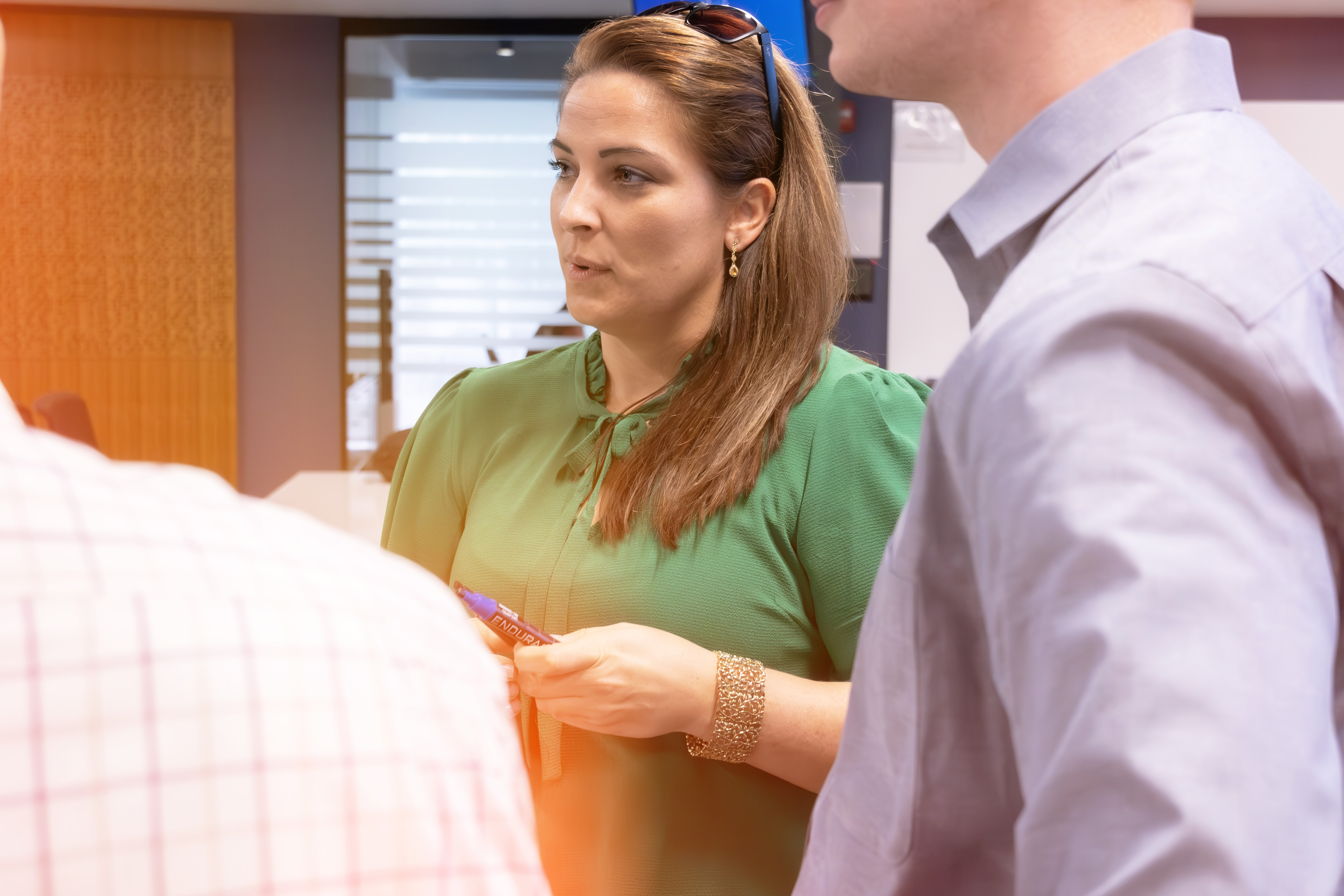 Female Employee in a Group Conversation