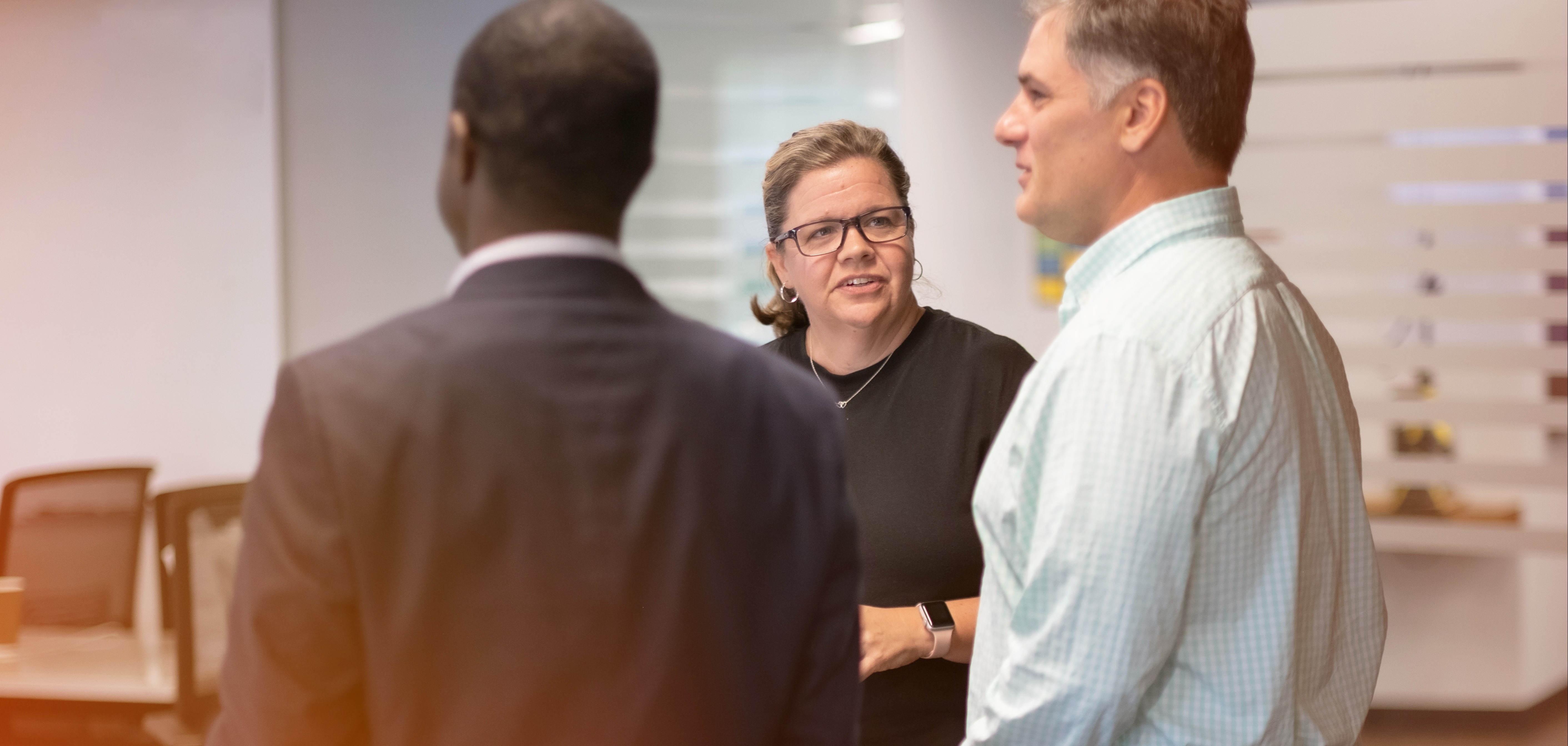 Three colleagues discussing work